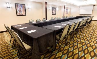 a conference room with long tables , chairs , and black tablecloths , set up for a meeting at Drury Inn & Suites Atlanta Morrow