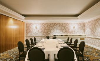 a large , elegant dining room with multiple tables and chairs arranged for a formal event at Marine Troon