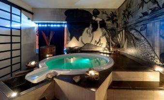 a modern living room with a large circular bathtub and a mural on the wall at Silver Hotel