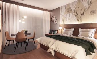 a modern bedroom with a large bed , white bedding , and a dining table in the corner at Mercure HAN Sur Lesse