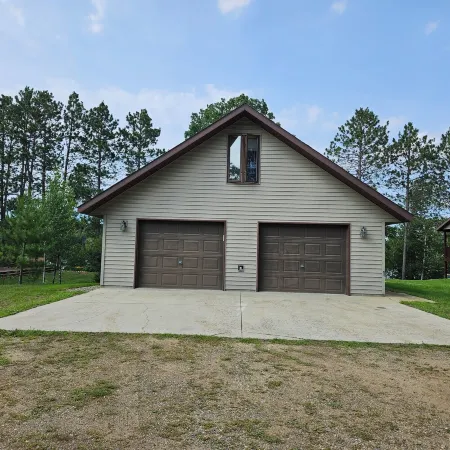 Three bedroom hide-a-way with spacious deck over looking Island Lake.
