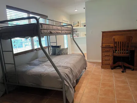 Spacious home directly on Lake Grassy canal. Boat house, hot tub & pool table