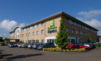 "a large building with a blue and white sign that reads "" holiday inn express "" prominently displayed" at Holiday Inn Express East Midlands Airport