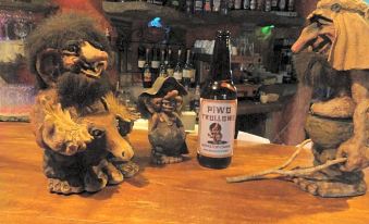 "a bottle of river swell brewery 's "" wurld twilight "" ale is sitting on a bar counter , accompanied by a bar setup" at Troll