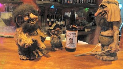 "a bottle of river swell brewery 's "" wurld twilight "" ale is sitting on a bar counter , accompanied by a bar setup" at Troll