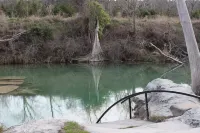 La Casita Verde Blanco on the banks of the river