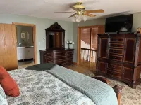 Waterfront retreat on 7 private wooded acres with beautiful sunset views.