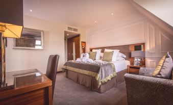 a large bed with a brown and white comforter is in the middle of a room at Slieve Donard