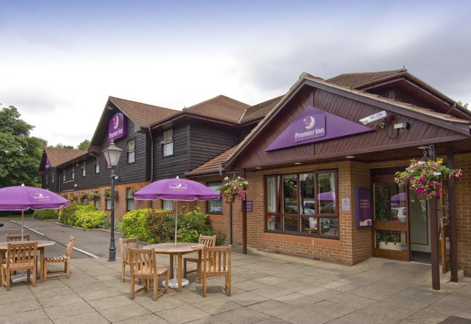 a purple and white striped awning over a restaurant , providing shade and protection from the elements at Premier Inn Maidstone (West Malling) hotel