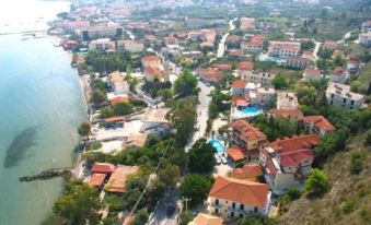 an aerial view of a small town by the water , with houses and roads visible at Anamar Zante Hotel