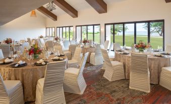 a well - decorated banquet hall with multiple tables and chairs set up for a formal event at Sheraton Kauai Coconut Beach Resort