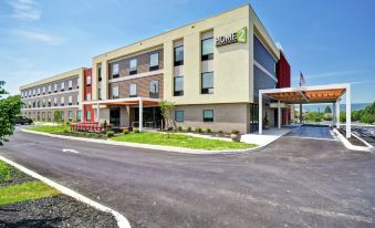 a modern hotel building with multiple floors , located in a residential area near a highway at Home2 Suites by Hilton Mechanicsburg