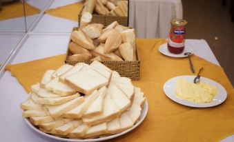 A table is set with plates and bowls filled to the brim, ready for an appetizer at La Casa We Stay