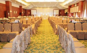 a large banquet hall with rows of tables and chairs set up for a formal event at Mulia Hotel
