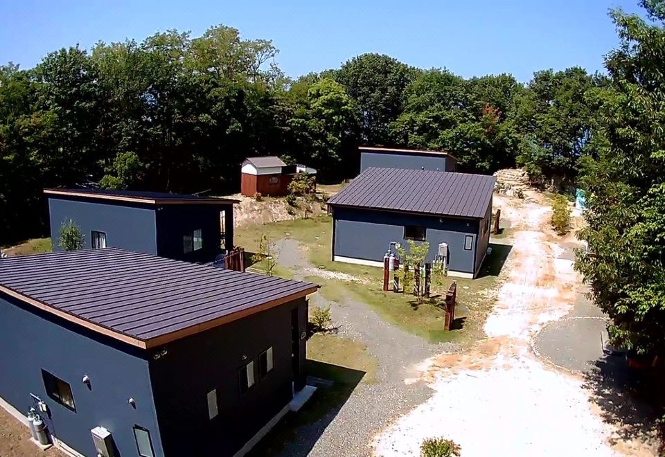 a bird 's eye view of a group of three blue and gray houses with metal roofs at Cottage Sunset-Village