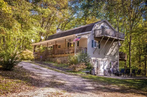 Luxury & Tranquility on 8 Acres Bordering Brush Creek! Secluded 3-Level Home.
