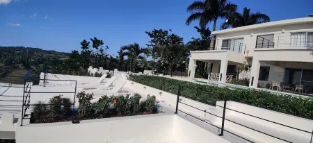 Luxurious villa set in a vast tropical garden, with panoramic sea and nature views.