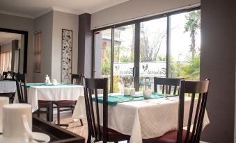 a dining room with tables and chairs arranged for a group of people to enjoy a meal together at Balmoral Lodge