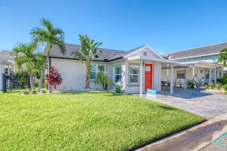 THIS STUNNING home is RENOVATED and furnished  W/Beach Access a block away!