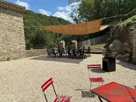 Old mill nestled in greenery in Drôme Provençale, hidden from view