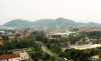 a cityscape with a mountain range in the background and a highway cutting through it at High Livin Apartment Baros