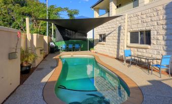 a small backyard with a pool and a shade structure , providing shade and protection from the sun at Best Western Caboolture Gateway Motel