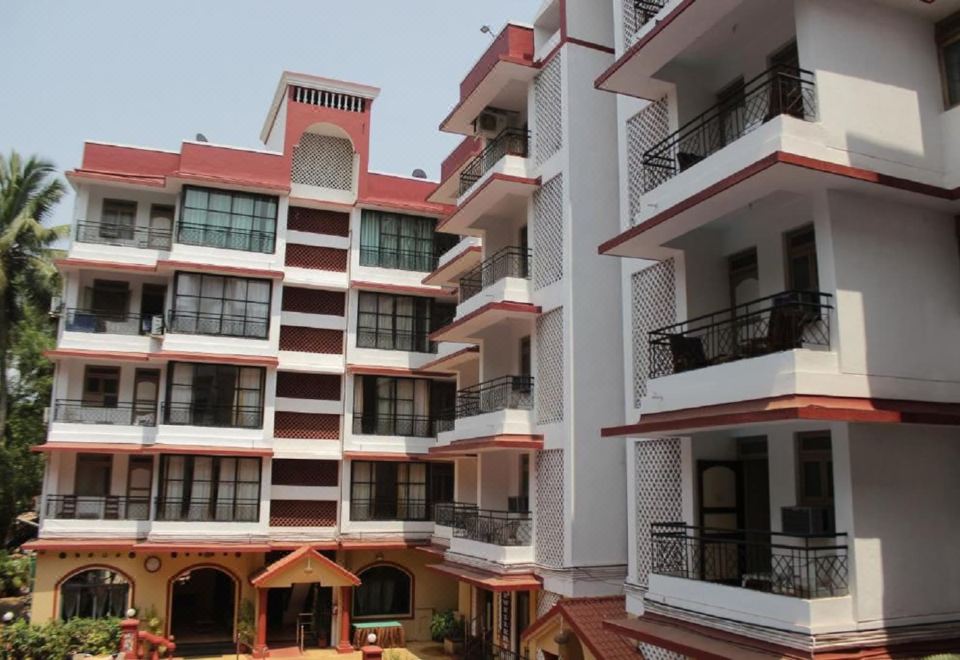 a large apartment building with multiple balconies and a courtyard area in front of it at The Horizon
