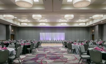 a large banquet hall with multiple tables and chairs set up for a formal event at Courtyard Omaha Bellevue at Beardmore Event Center