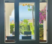 Modern garden apartment with a fantastic view of the sea and a private garden