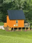 Tiny cabin sits by a bubbling, stocked creek. Pet friendly for a fee, hot tub
