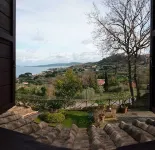 Breathtaking view of the lake and castle surrounded by holm oaks and oaks