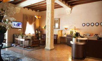 a large hotel lobby with various seating options , including couches , chairs , and a dining table at Hotel Carmel Santa Monica