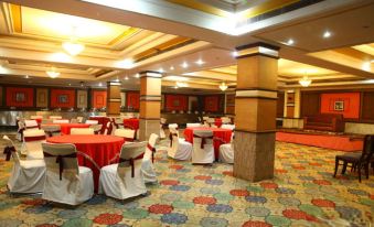a large banquet hall with multiple tables and chairs set up for a formal event at Jalandhar Shangrila Hotel