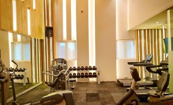 a well - equipped gym with various exercise equipment , including treadmills and weight machines , as well as a yoga studio at Grand Singgie Hotel