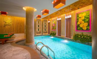 There is a spacious indoor swimming pool with an adjacent outdoor jacuzzi and spa at Ta Prohm Hotel & Spa