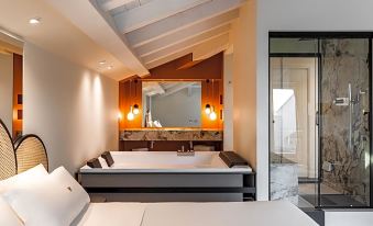 a modern bathroom with a bathtub and a bathtub in the middle of the room at Seebay Hotel