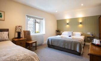 a bedroom with two beds , one on the left and one on the right side of the room at The Durant Arms