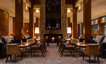 a dining room with a fireplace in the background , creating a cozy atmosphere for guests at Druids Glen Resort