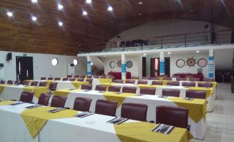 a large conference room with rows of chairs arranged in a semicircle , providing seating for a group of people at Aqua Safari Resort
