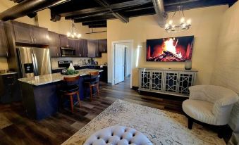 a cozy living room with a dining area and a fireplace , creating a warm and inviting atmosphere at The Inn at Stone Mill