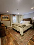 Private room with a queen bed at The Town House Inn
