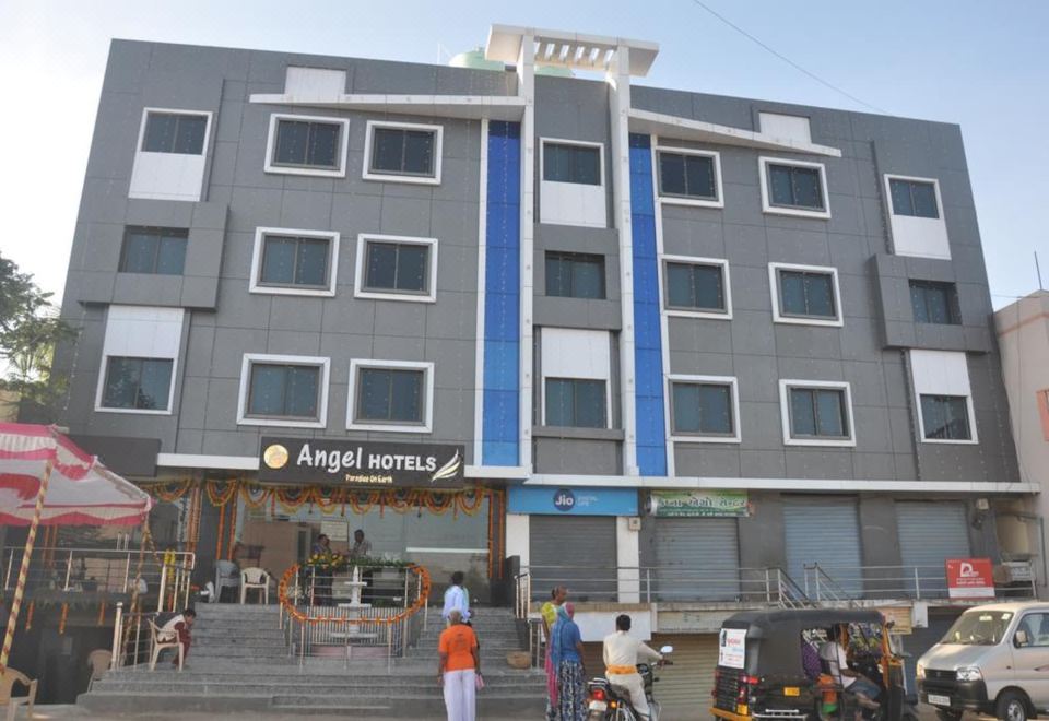 "a large building with a blue sign that says "" angel hotel "" in front of it" at Angel Hotels