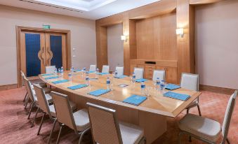a conference room set up for a meeting , with chairs arranged in a semicircle around a large table at Lykia World Antalya