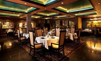 a large dining room with multiple tables and chairs arranged for a group of people to enjoy a meal at Carson Valley Inn