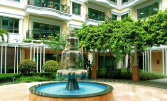 The hotel is situated in a lush, green environment with surrounding vegetation at Guangzhou Feiyang Apartment