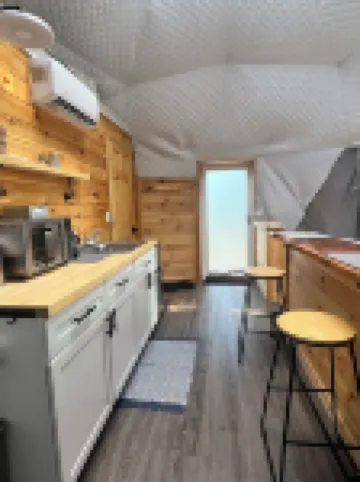 Cozy lakeside glamping dome with fireplace, AC and full bath.