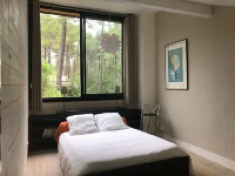 Wooden house in the golf, between forest, lake and ocean