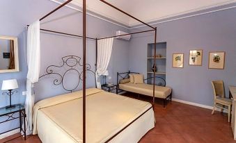 a bedroom with two beds , one on the left and one on the right side of the room at Etna Hotel