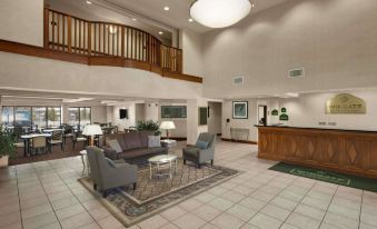 a large hotel lobby with a reception desk , couches , and chairs arranged in a seating area at Holiday Inn Allentown-Bethlehem