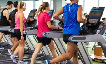 a group of people working out in a gym , using treadmills and other cardio equipment at Tien Loc Palace Hotel